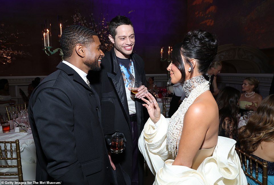 Three's a crowd? Kim Kardashian and ex Pete Davidson enjoyed a friendly reunion inside the 2023 Met Gala on Monday , as they led the fun-loving stars partying the night away at the event (pictured with Usher)