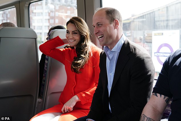 Kate Middleton, pictured here with her husband Prince William on the Elizabeth Line on Thursday, said her eldest son is 'excited' about the coronation of his grandfather
