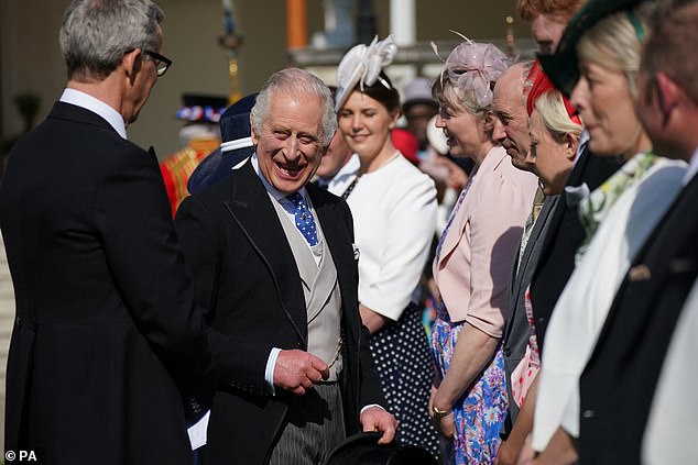 King Charles appeared in high spirits as he spoke with guests attending his first Buckingham Palace garden party as monarch